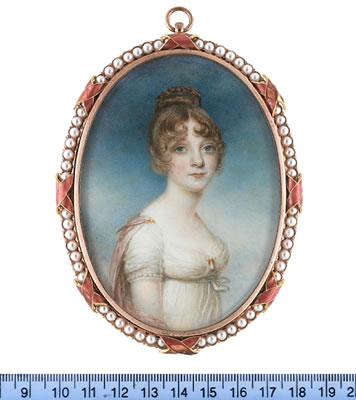 William Grimaldi : A Lady, wearing white dress with a strand of pearls to the trim of her sleeve, a gold and pearl pendent brooch at her corsage, pink stole fastened at her shoulders with a gold brooch pin, her hair upswept and held in place with a tortoiseshell comb.